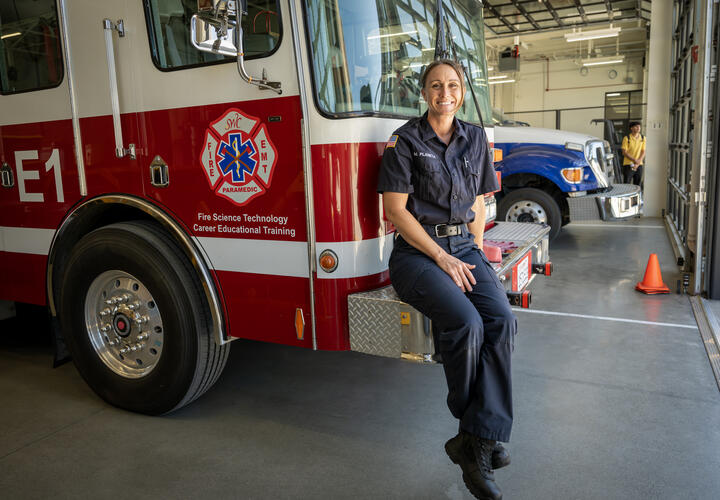 female fire cadet posing on a fire engine 
