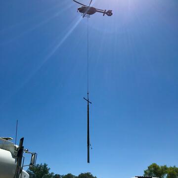 Helicopter setting a power pole