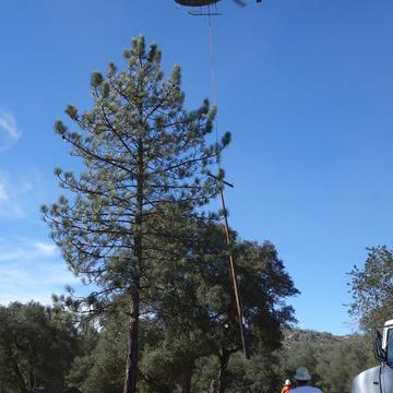 A helicopter setting a power pole in Ramona