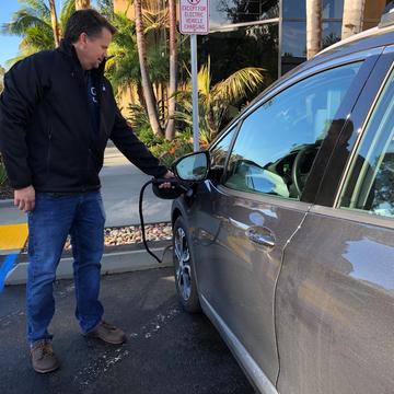   Tom Lunneberg charging his EV at MA Engineers, one of the Power Your Drive locations