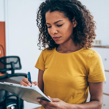 Woman in yellow shirt with a checklist