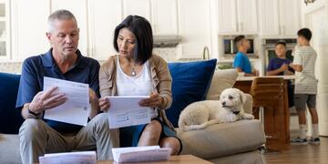 A couple sits on the couch, reviewing their SDG&E bill