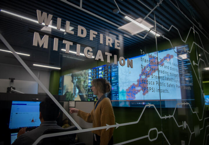 A photo of the exterior of SDG&E's WCRC, with the words "wildfire mitigation" displayed on the glass.